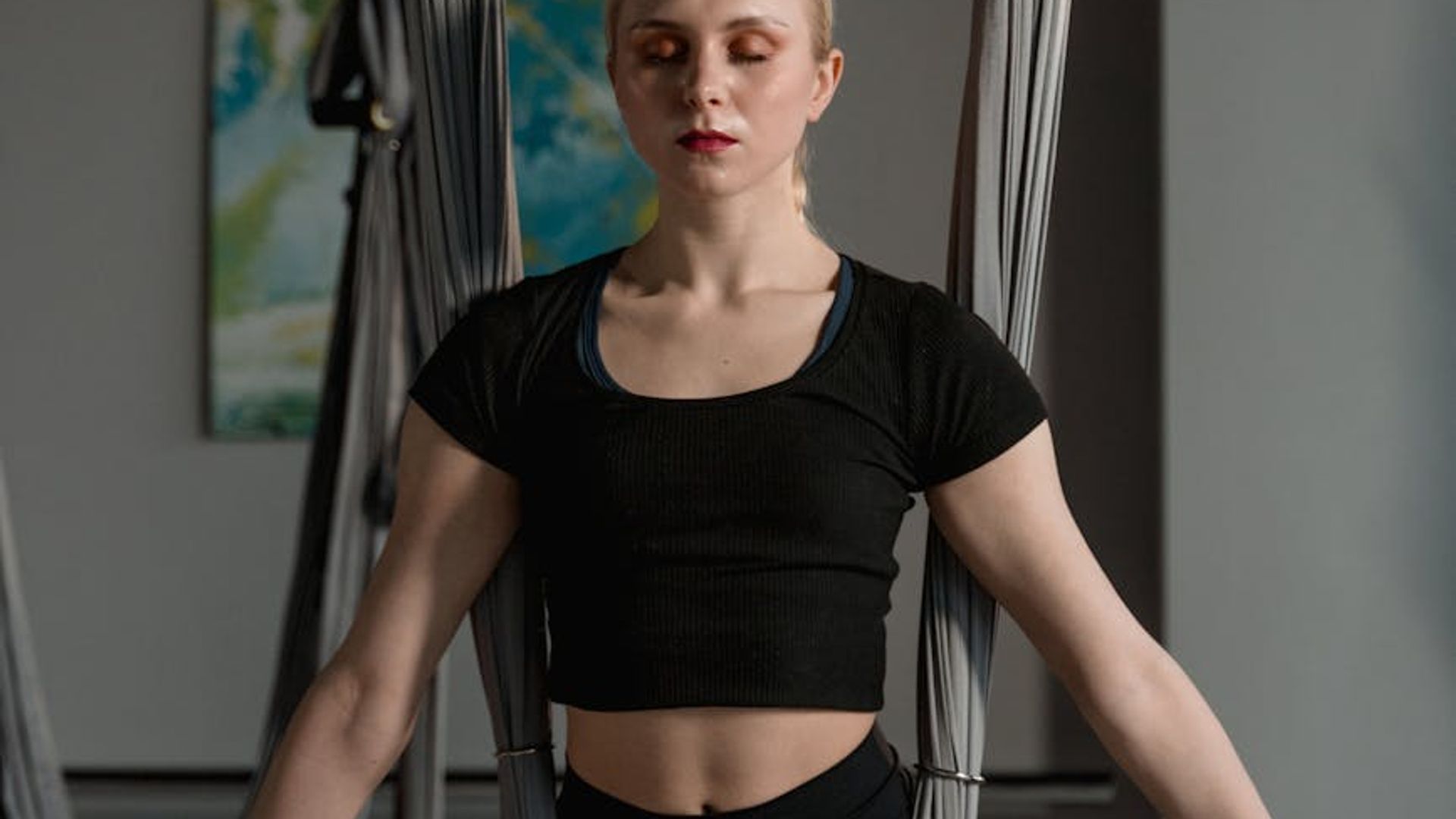 A calm and focused person in a flowing yoga posture.